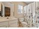 Bright bathroom with a large vanity, toilet, and shower/tub combo with shower curtain at 1208 Copper Creek Dr, Durham, NC 27713