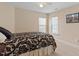 Serene bedroom featuring a bed, ceiling fan, and windows letting in natural light at 1208 Copper Creek Dr, Durham, NC 27713
