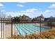 View of the community pool area with mature trees in the background, promising leisure and relaxation at 1208 Copper Creek Dr, Durham, NC 27713