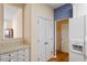 Kitchen featuring white cabinets, laminate countertops, and view to adjoining area at 1208 Copper Creek Dr, Durham, NC 27713