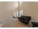 Spacious living room featuring a comfortable sofa, sliding glass doors, and ample natural light at 1208 Copper Creek Dr, Durham, NC 27713