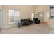 Open-concept living room with a leather sofa and a view of the entryway and dining area at 1208 Copper Creek Dr, Durham, NC 27713