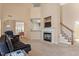 Bright living room with fireplace, carpet, stairs and a view of the dining room at 1208 Copper Creek Dr, Durham, NC 27713