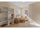 Inviting living room area with plush chair, side table, and bookshelves by a window for natural light at 1208 Copper Creek Dr, Durham, NC 27713