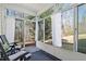 Relaxing sunroom with seating, large windows, and views of the outdoors at 1208 Copper Creek Dr, Durham, NC 27713