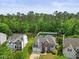 Aerial view of a stunning two-story home nestled in a lush neighborhood with mature trees and well-maintained lawns at 121 Talley Ridge Dr, Holly Springs, NC 27540