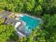 Aerial view of the community pool surrounded by trees and a pool house at 121 Talley Ridge Dr, Holly Springs, NC 27540