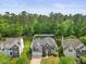 Expansive aerial view of a charming home surrounded by lush greenery, offering a serene and private setting at 121 Talley Ridge Dr, Holly Springs, NC 27540