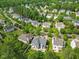 Panoramic aerial view of a residential neighborhood with lush greenery, highlighting homes and tree-lined streets at 121 Talley Ridge Dr, Holly Springs, NC 27540