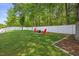 Relaxing backyard offers fire pit with Adirondack chairs for outdoor enjoyment at 121 Talley Ridge Dr, Holly Springs, NC 27540