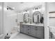 Modern bathroom features double vanity, large mirror, and glass-enclosed shower with subway tiles at 121 Talley Ridge Dr, Holly Springs, NC 27540