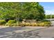 Entrance to Braxton Village surrounded by lush landscaping at 121 Talley Ridge Dr, Holly Springs, NC 27540
