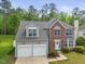 Beautiful exterior elevation of the home with mature trees and well-manicured landscaping at 121 Talley Ridge Dr, Holly Springs, NC 27540