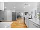 Modern kitchen features stainless steel appliances, white cabinets, and hardwood floors at 121 Talley Ridge Dr, Holly Springs, NC 27540