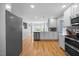 Updated kitchen with stainless steel appliances, white cabinets, and hardwood floors at 121 Talley Ridge Dr, Holly Springs, NC 27540