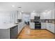 Bright, updated kitchen with stainless steel appliances, white cabinetry and hardwood floors at 121 Talley Ridge Dr, Holly Springs, NC 27540