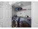 Convenient laundry room featuring modern washer and dryer units and ample storage space at 121 Talley Ridge Dr, Holly Springs, NC 27540