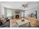 Spacious living room featuring a fireplace, hardwood floors, and an open floor plan at 121 Talley Ridge Dr, Holly Springs, NC 27540