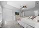 Bright primary bedroom features neutral walls, plush carpet, ceiling fan, and TV at 121 Talley Ridge Dr, Holly Springs, NC 27540
