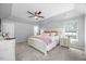 Bright primary bedroom features neutral walls, plush carpet, and a ceiling fan at 121 Talley Ridge Dr, Holly Springs, NC 27540
