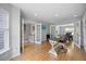 Bright office with hardwood floors and plenty of natural light flows seamlessly into dining room at 121 Talley Ridge Dr, Holly Springs, NC 27540