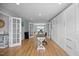 This stylish office features hardwood floors, white built-ins, and french doors to the dining room at 121 Talley Ridge Dr, Holly Springs, NC 27540