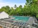 Community pool with lounge chairs, tables, and a green tree backdrop at 121 Talley Ridge Dr, Holly Springs, NC 27540