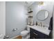 Stylish powder room with elegant fixtures, a decorative mirror, and a modern vanity at 121 Talley Ridge Dr, Holly Springs, NC 27540