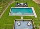 Aerial view showcasing a beautiful property with a pool, decks, and manicured lawns surrounded by lush greenery at 123 Beech Forest Way, Pittsboro, NC 27312