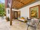 Inviting back patio with stone flooring, comfortable seating, and outdoor dining area offers a relaxing space at 123 Beech Forest Way, Pittsboro, NC 27312
