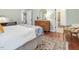 Bedroom with wood dresser, bed, and view into the bathroom at 123 Beech Forest Way, Pittsboro, NC 27312