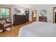 Comfortable bedroom featuring a dresser, hardwood floors and natural light at 123 Beech Forest Way, Pittsboro, NC 27312