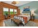 Bright bedroom features hardwood floors, a unique tapestry, and abundant natural light through many windows at 123 Beech Forest Way, Pittsboro, NC 27312