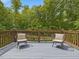 Relaxing deck area with comfortable seating, offering a peaceful outdoor retreat with views of the surrounding greenery at 123 Beech Forest Way, Pittsboro, NC 27312