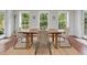Bright dining room with wood table, seating for four, and three windows overlooking lush greenery at 123 Beech Forest Way, Pittsboro, NC 27312