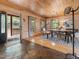 Dining room with wood table, modern chandelier, light wood paneled walls, and tiled entry at 123 Beech Forest Way, Pittsboro, NC 27312