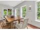 Dining room with wood table, seating for four, and a door leading to the porch at 123 Beech Forest Way, Pittsboro, NC 27312