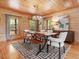 Dining room featuring wood paneling, chandelier lighting, windows, and hardwood floors at 123 Beech Forest Way, Pittsboro, NC 27312