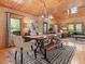 Dining room featuring wood paneling, chandelier lighting, windows, hardwood floors, and plush seating at 123 Beech Forest Way, Pittsboro, NC 27312