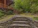 Stone steps lead to a backyard with mossy ground and wooded perimeter at 123 Beech Forest Way, Pittsboro, NC 27312