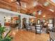 The open-concept living room features wood paneling, a stone fireplace, and seamless flow to the kitchen at 123 Beech Forest Way, Pittsboro, NC 27312