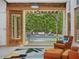 Living room with comfortable chairs and view of the pool and patio area at 123 Beech Forest Way, Pittsboro, NC 27312