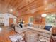 Open concept floor plan with seamless flow between living, dining, and kitchen areas, with wood paneled walls at 123 Beech Forest Way, Pittsboro, NC 27312