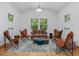 Cozy living room featuring unique furniture, a stylish rug, and an abundance of natural light from the windows at 123 Beech Forest Way, Pittsboro, NC 27312