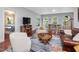 Cozy and bright living room area with a blend of seating and access to the dining room and a separate bedroom at 123 Beech Forest Way, Pittsboro, NC 27312