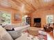 Comfortable living room area showcasing a neutral color palette, plush furnishings, and wood paneled walls at 123 Beech Forest Way, Pittsboro, NC 27312