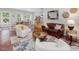 Bright living room with lots of natural light offers a seating area plus view of dining space and stairs at 123 Beech Forest Way, Pittsboro, NC 27312