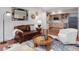 Cozy living area with a comfortable sofa and armchair, creating a welcoming space adjacent to the kitchen at 123 Beech Forest Way, Pittsboro, NC 27312