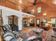 Living room featuring wood paneling, fireplace, wood-burning stove, windows, and an oriental-style rug at 123 Beech Forest Way, Pittsboro, NC 27312
