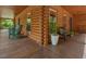 Wraparound porch with log railing, seating and views of the surrounding trees at 123 Beech Forest Way, Pittsboro, NC 27312